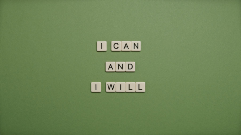 Inspirational message 'I Can and I Will' spelled with tile letters on a green background.
